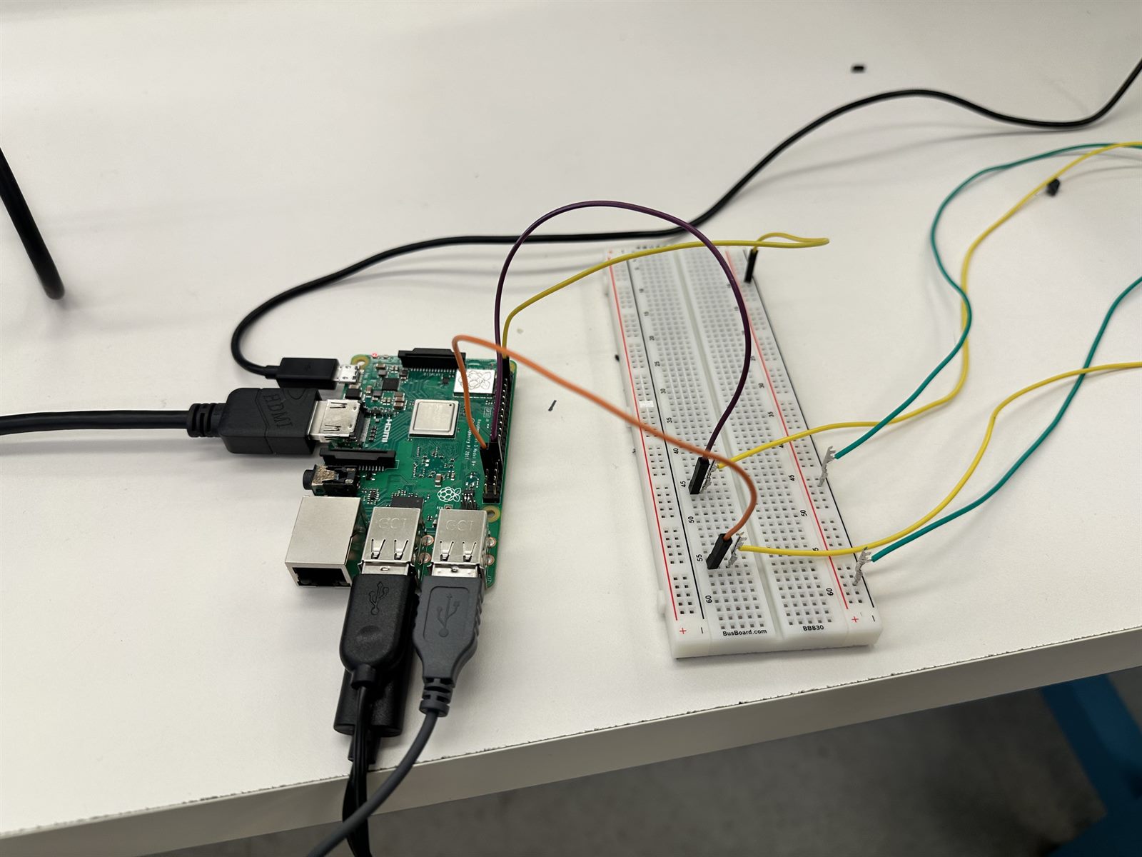 Raspberry Pi wired to a breadboard on the lab bench during hardware bring-up