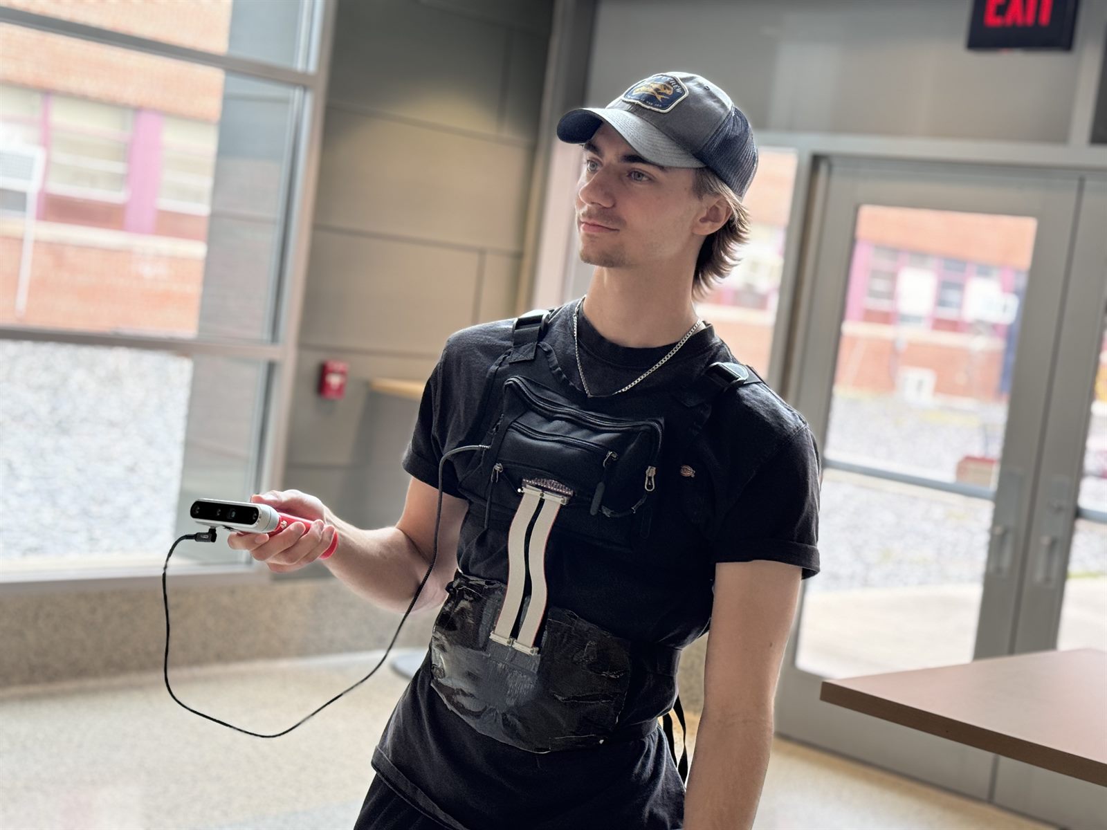 Teammate wearing the final harness and holding the Intel RealSense depth camera