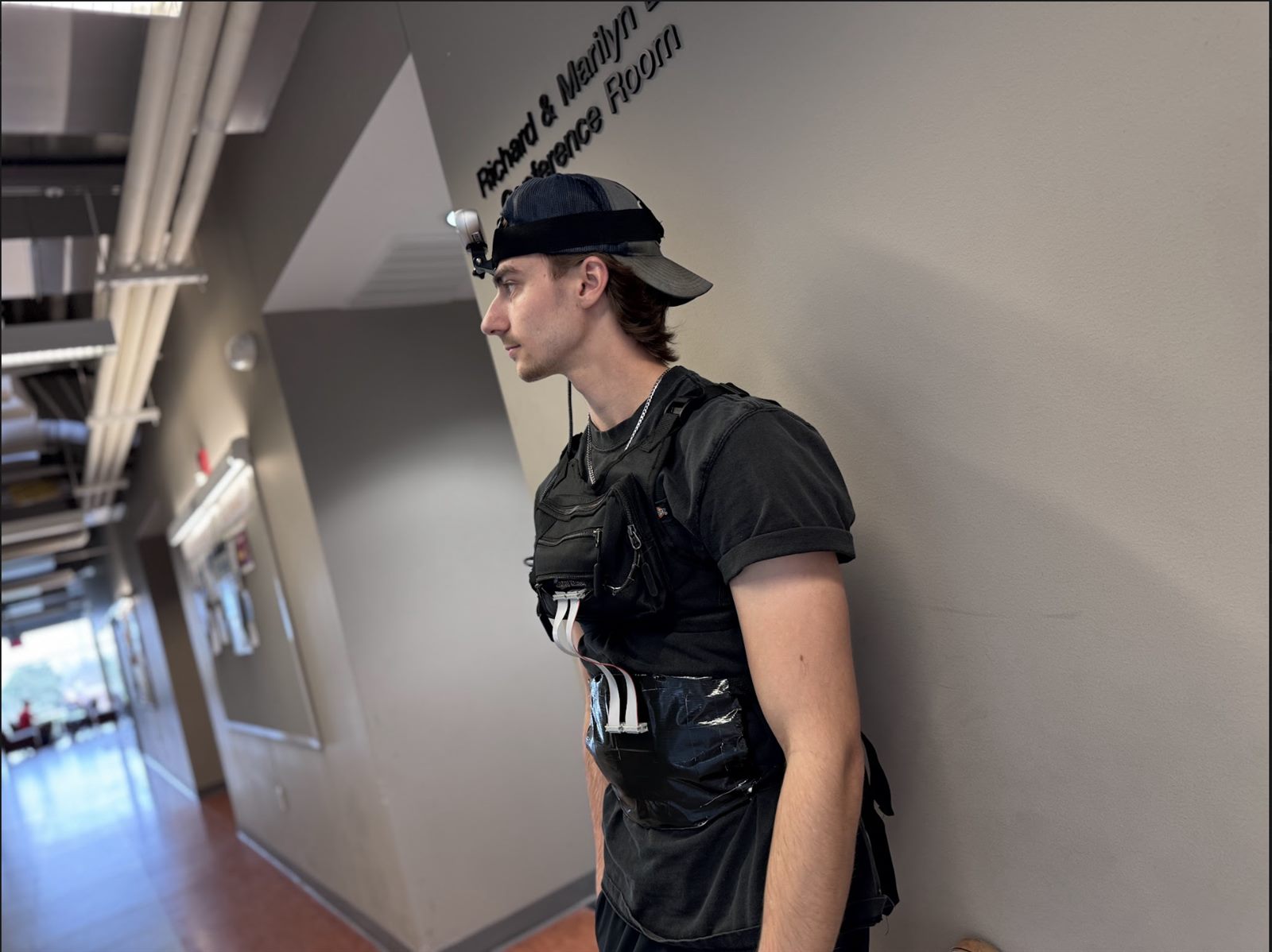 Side view of the vest showing the haptic driver board and ribbon cabling running to the harness