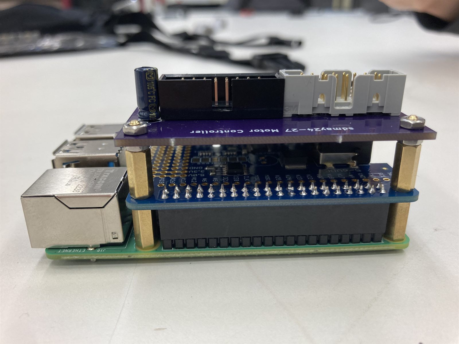 The team's custom sdmay24-27 motor controller board stacked on the Raspberry Pi